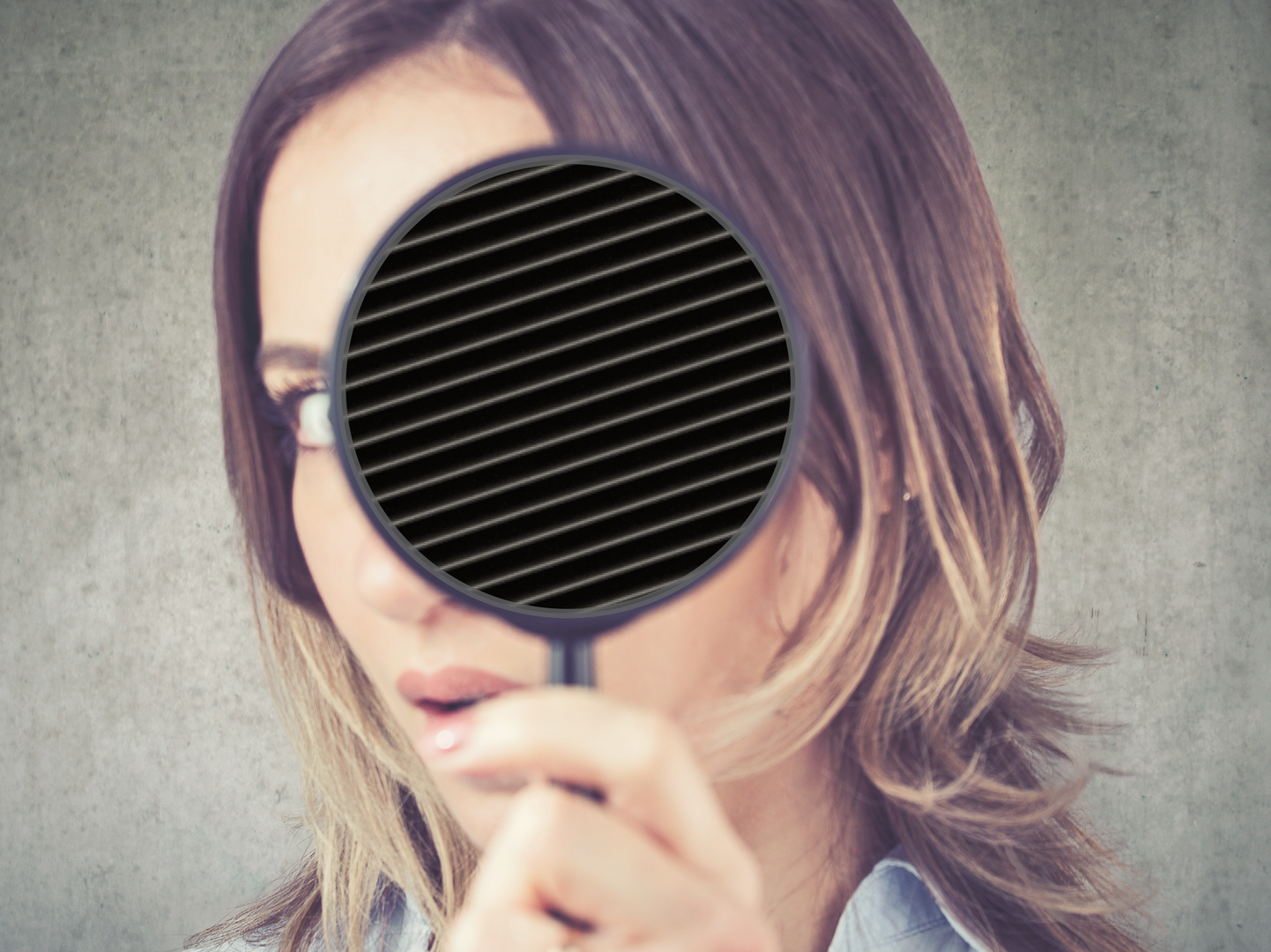 Woman looking at perfect thread rolling die profile with magnifying glass